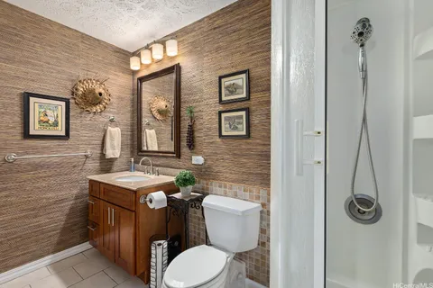 a bathroom with a toilet a sink and mirror
