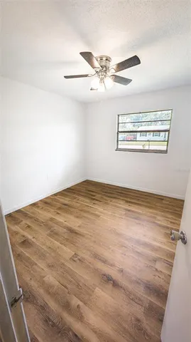 a view of a room with wooden floor