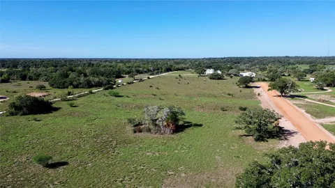 an aerial view of a houses with a yard