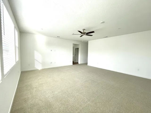 an empty room with a empty space and windows