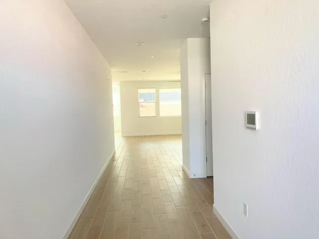 a view of a hallway with a wooden floor