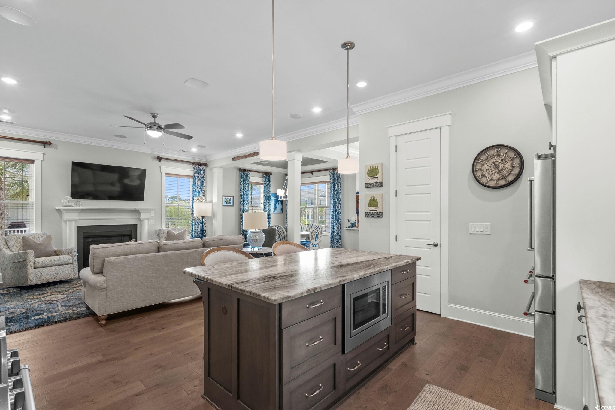 8245 Sandlapper Way Myrtle Beach, SC 29572 - Photo 15 of 40 Kitchen featuring dark wood-style flooring, healthy amount of natural light, recessed lighting, stainless steel appliances, and ceiling fan