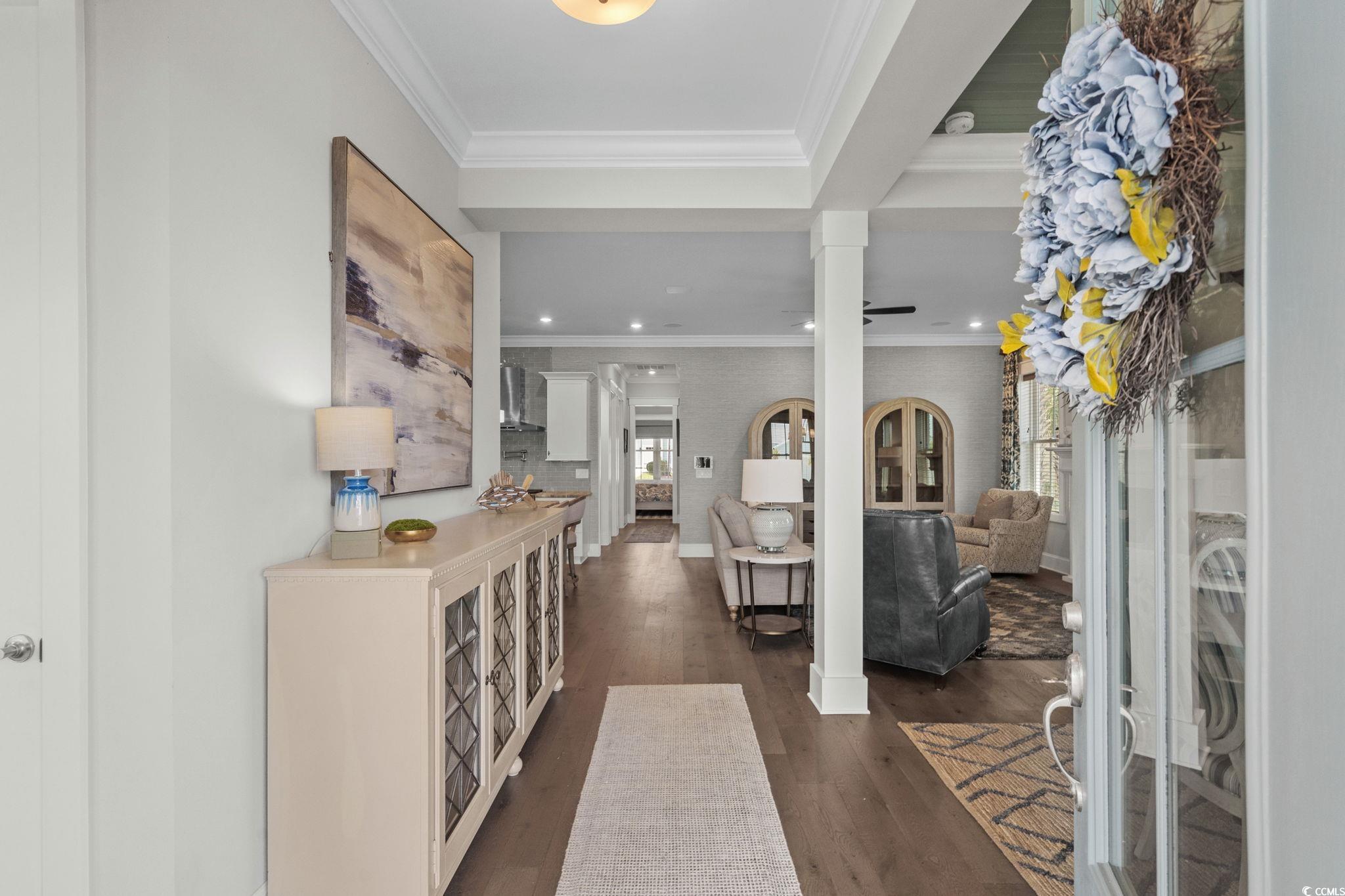 8245 Sandlapper Way Myrtle Beach, SC 29572 - Photo 9 of 40 Entryway with crown molding, dark wood-style flooring, decorative columns, and recessed lighting