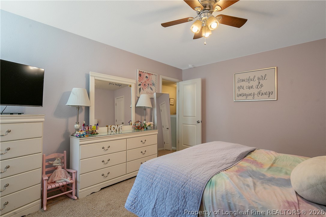 340 Battery Way Bunnlevel, NC 28323 - Photo 41 of 50 a bedroom with a bed and a flat screen tv
