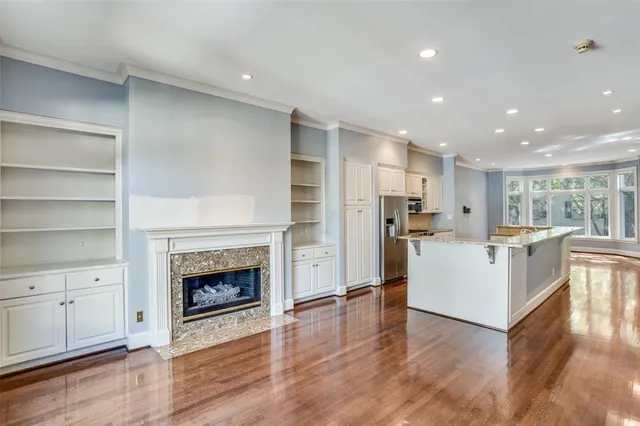 a view of a kitchen with furniture and wooden floor