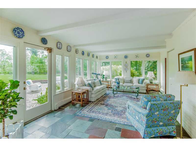 490 Hollow Tree Ridge Road Darien, CT 06820 - Photo 11 of 25 a living room with furniture and a large window