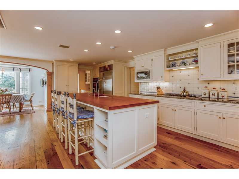 490 Hollow Tree Ridge Road Darien, CT 06820 - Photo 13 of 25 a kitchen with stainless steel appliances kitchen island granite countertop a stove a sink a refrigerator and white cabinets with wooden floor