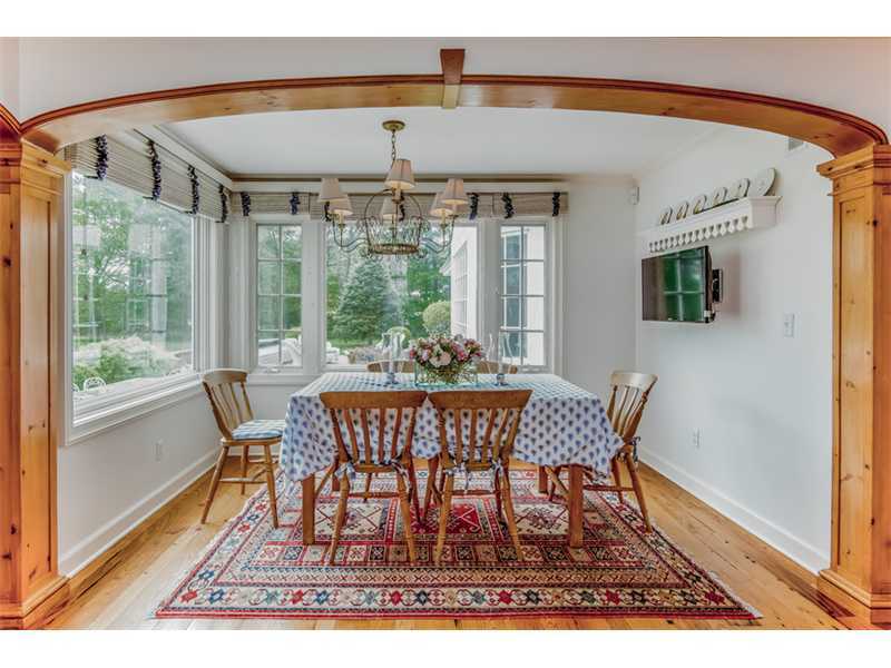 490 Hollow Tree Ridge Road Darien, CT 06820 - Photo 14 of 25 a view of a dining room with furniture wooden floor and a potted plant