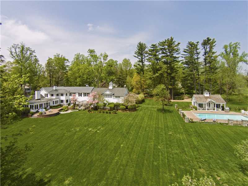 490 Hollow Tree Ridge Road Darien, CT 06820 - Photo 2 of 25 a view of house with a yard and trees in the background