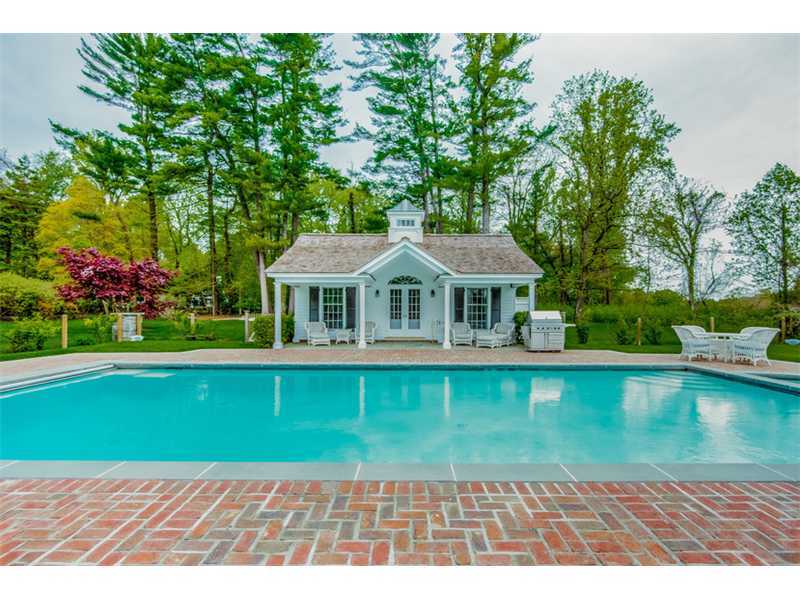 490 Hollow Tree Ridge Road Darien, CT 06820 - Photo 21 of 25 a front view of a house with swimming pool having outdoor seating