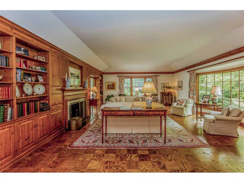 490 Hollow Tree Ridge Road Darien, CT 06820 - Photo 7 of 25 a living room with furniture a fireplace and a book shelf