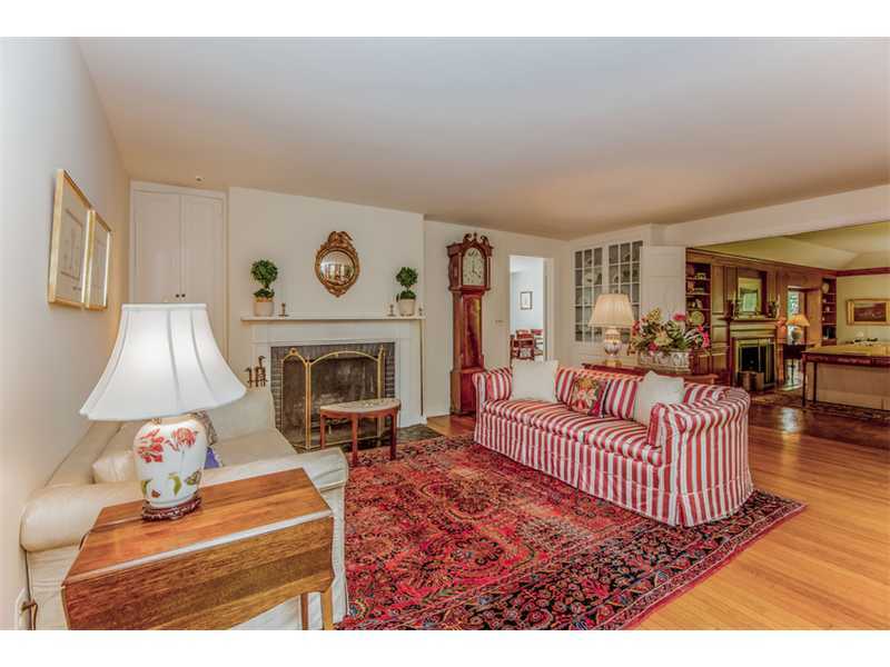 490 Hollow Tree Ridge Road Darien, CT 06820 - Photo 8 of 25 a living room with furniture a fireplace and a table