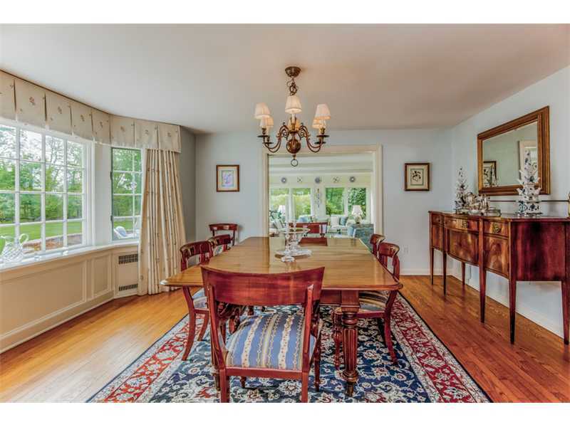 490 Hollow Tree Ridge Road Darien, CT 06820 - Photo 10 of 25 a view of a dining room with furniture a chandelier and wooden floor