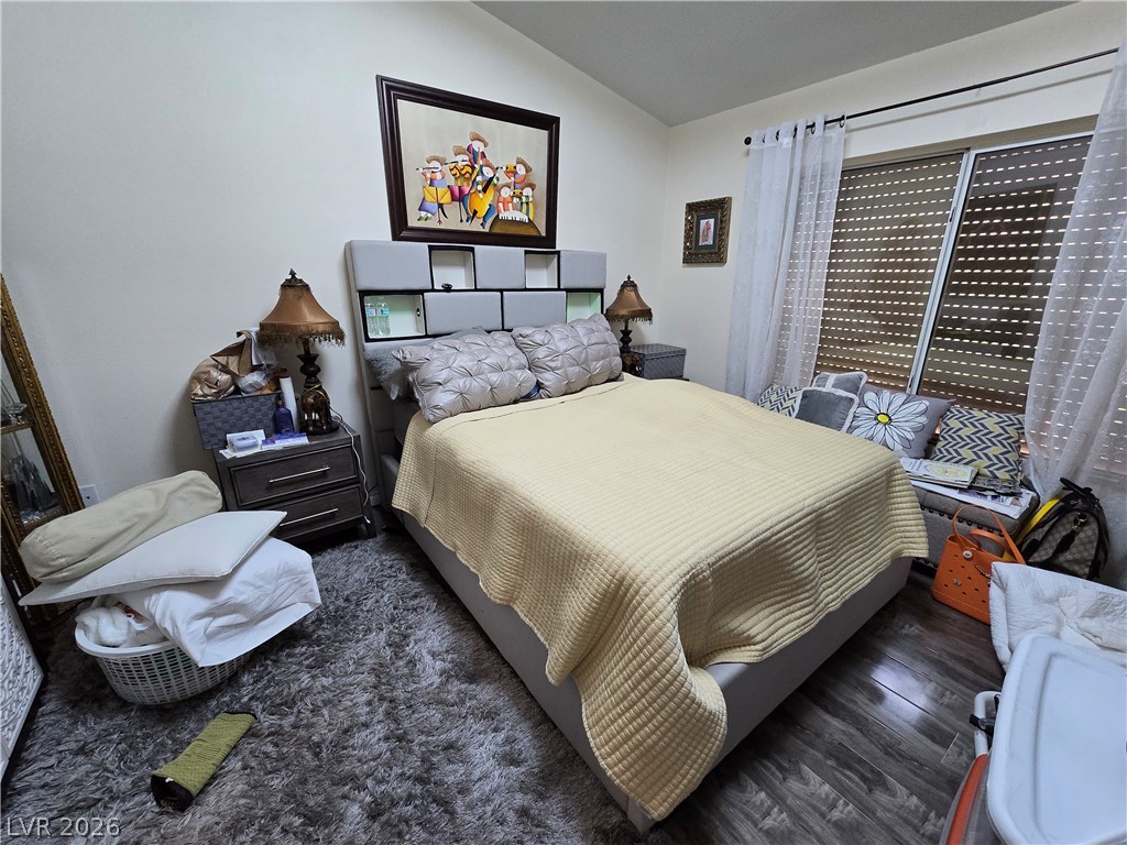 415 Golden State Street Henderson, NV 89012 - Photo 8 of 11 Rich wood flooring pairs with ample natural light from the wide sliding window.