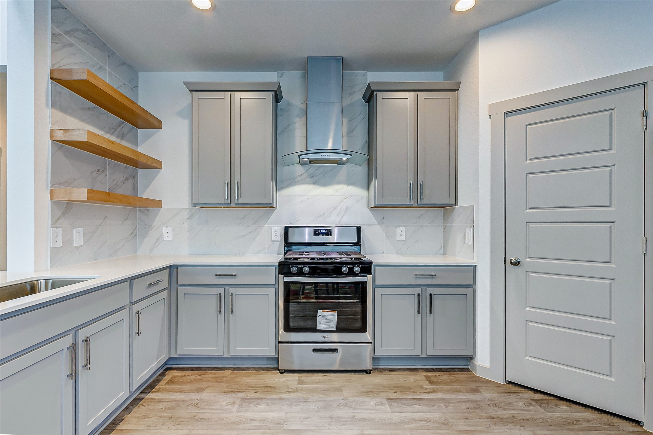 12514 Walmgate Court Houston, TX 77047 - Photo 11 of 37 a kitchen with a stove and a sink