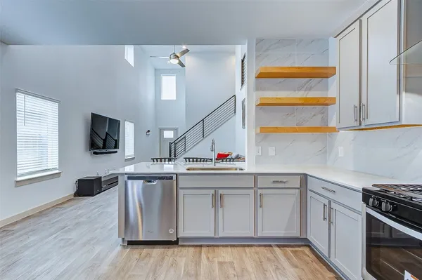 a kitchen with stainless steel appliances a stove and microwave