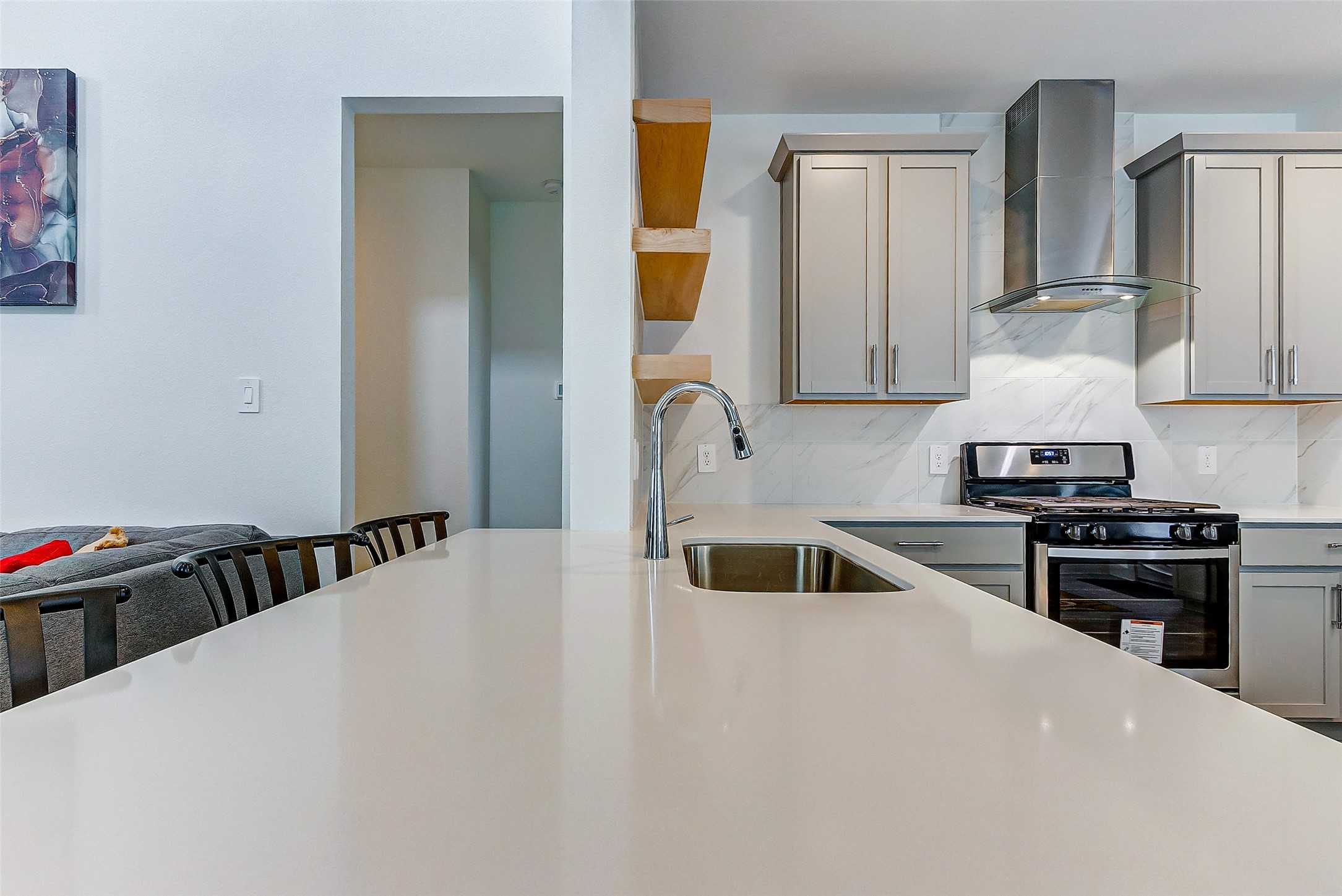 12514 Walmgate Court Houston, TX 77047 - Photo 13 of 37 a kitchen with a sink and a stove top oven with wooden floor