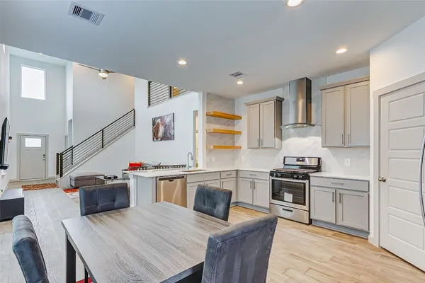 a kitchen with granite countertop a sink stove and refrigerator