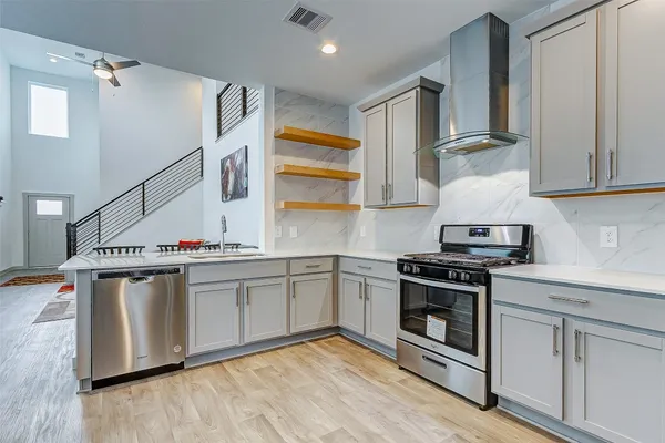 a kitchen with stainless steel appliances granite countertop a stove and a sink