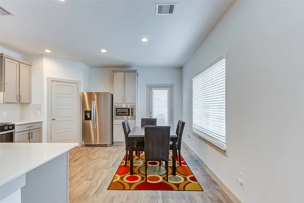 a dining room with furniture and a rug