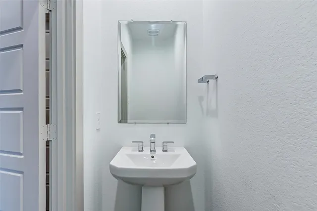 a bathroom with a sink a mirror and a toilet