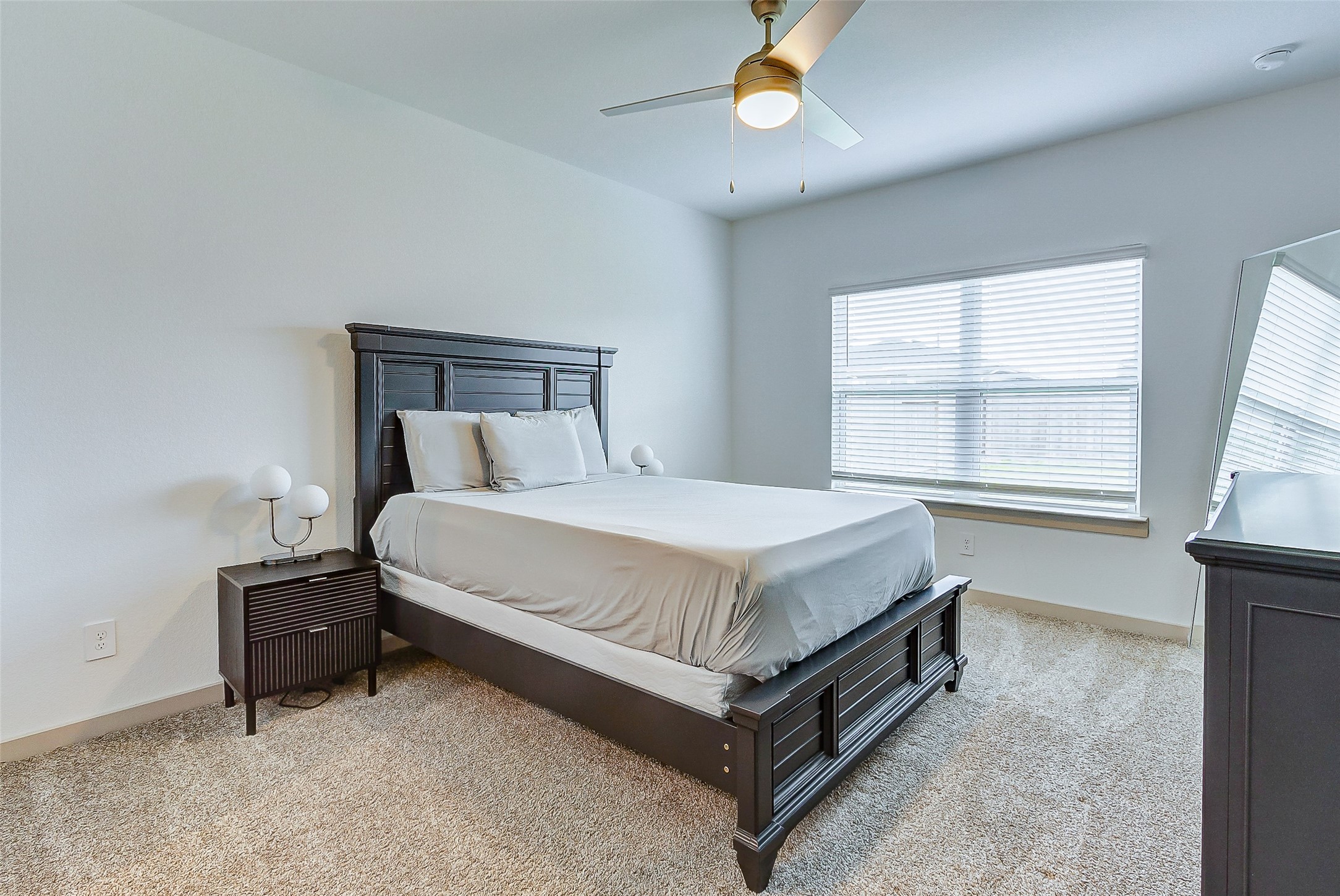 12514 Walmgate Court Houston, TX 77047 - Photo 23 of 37 a bed sitting in a bedroom next to a window