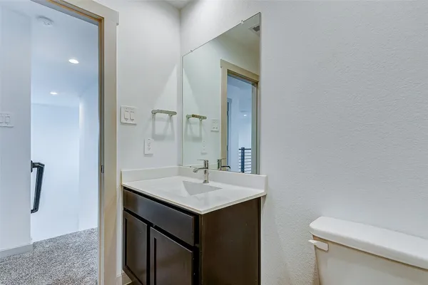 a bathroom with a sink toilet and mirror