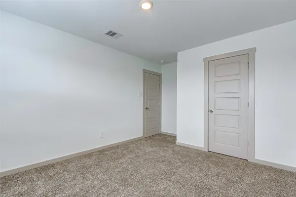 a view of an empty room and closet area