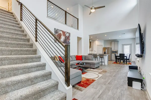 a living room with lots of furniture and a wooden floor