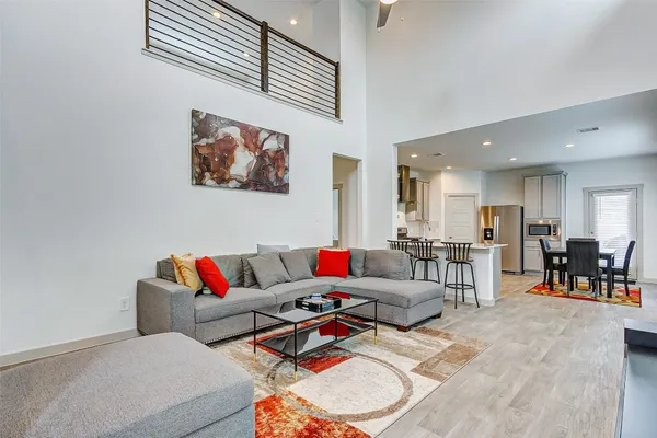 a living room with furniture and wooden floor
