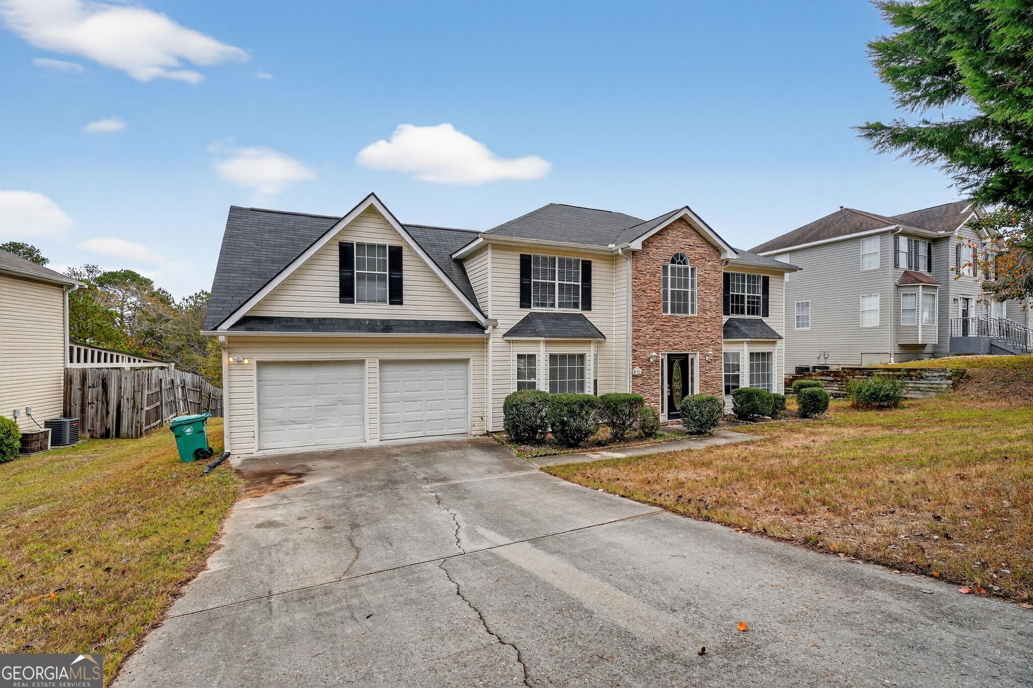 2391 Harmony Ridge Court Lithonia, GA 30058 - Photo 1 of 35 a front view of a house with a yard and garage