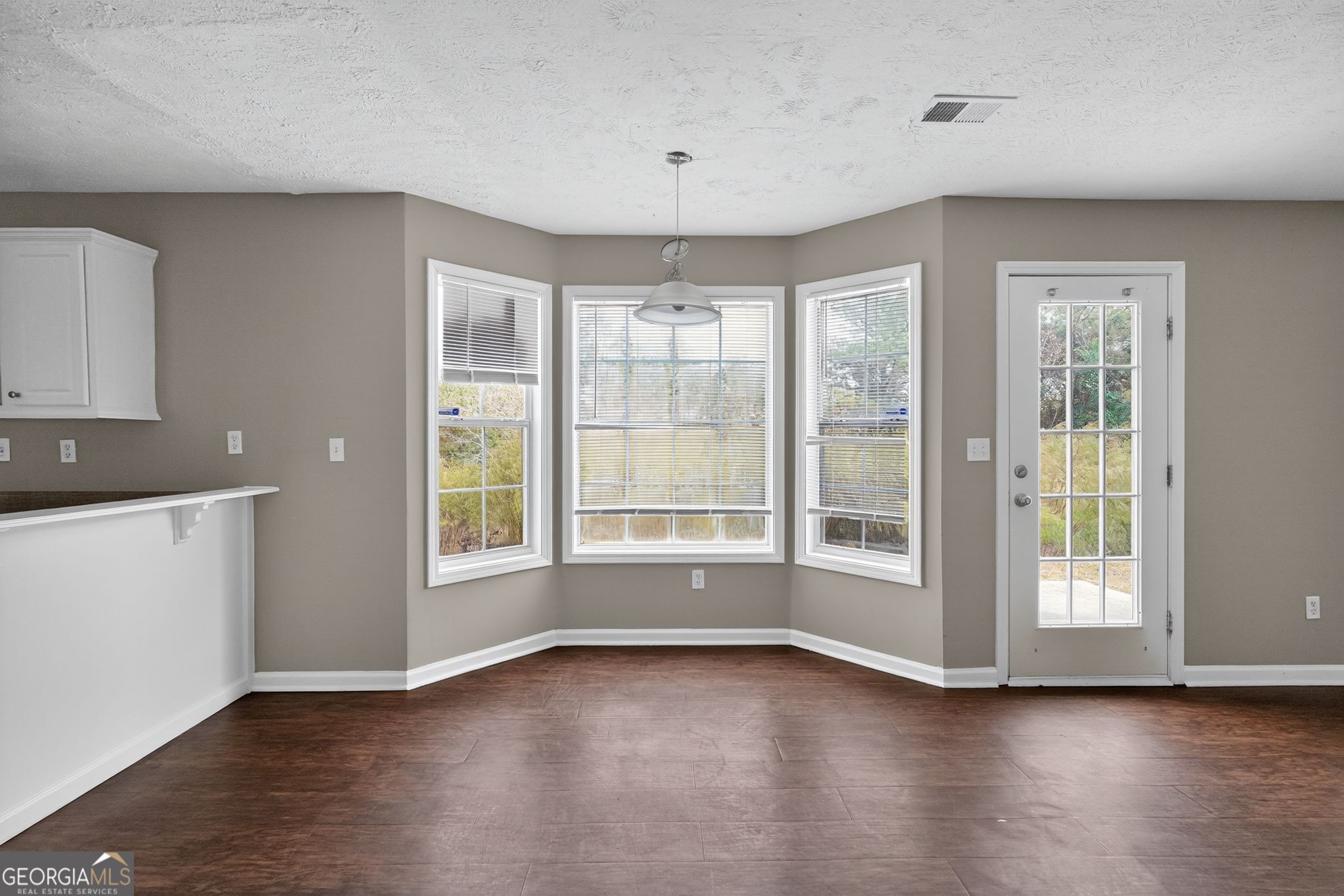 2391 Harmony Ridge Court Lithonia, GA 30058 - Photo 19 of 35 an empty room with wooden floor and windows