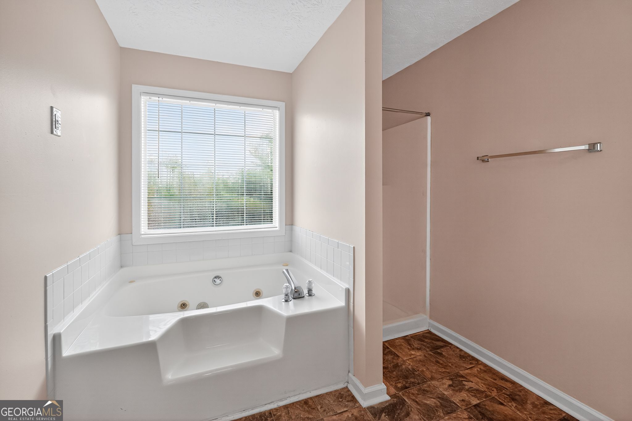 2391 Harmony Ridge Court Lithonia, GA 30058 - Photo 22 of 35 a bathroom with a bathtub and a window
