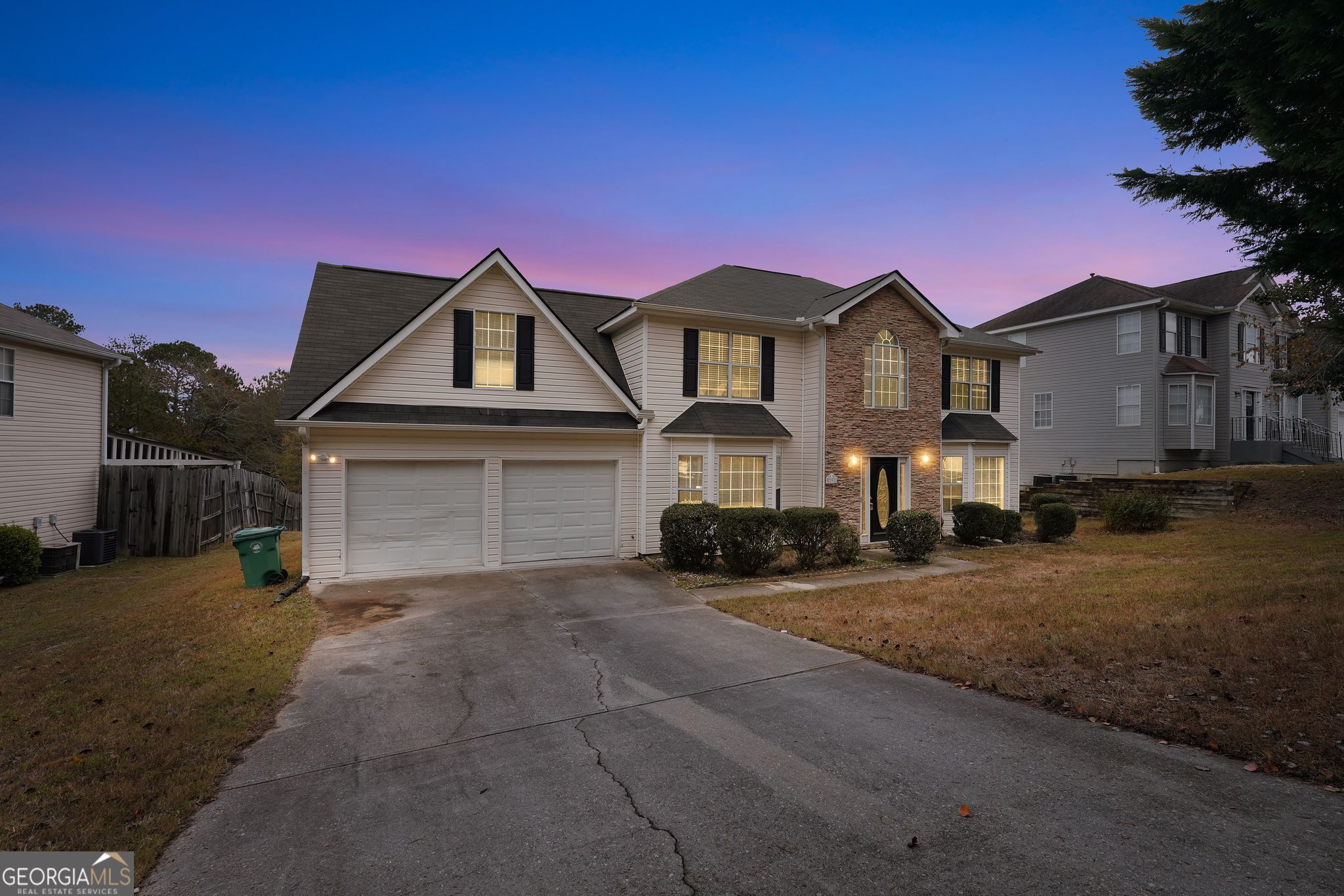 2391 Harmony Ridge Court Lithonia, GA 30058 - Photo 4 of 35 a front view of a house with a yard and garage