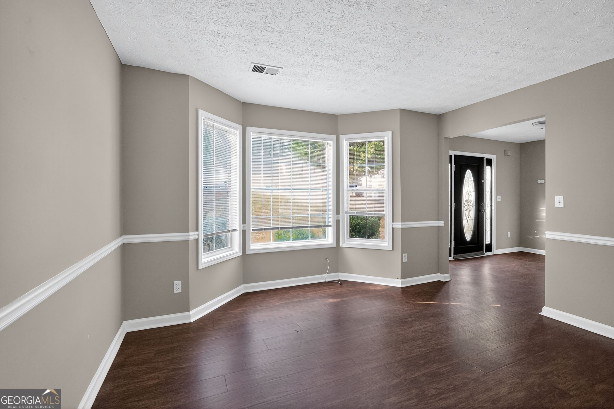 2391 Harmony Ridge Court Lithonia, GA 30058 - Photo 9 of 35 an empty room with wooden floor and windows