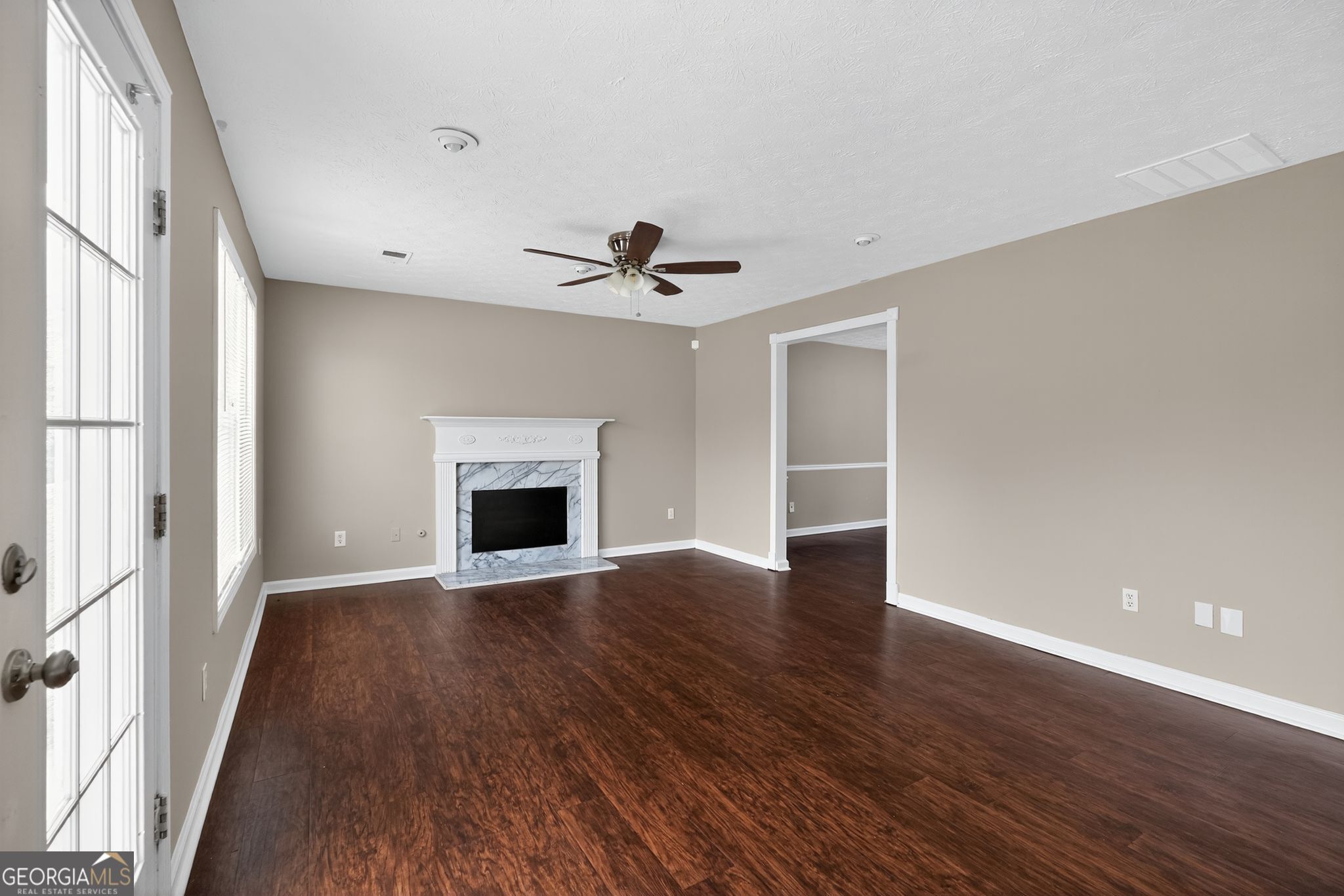 2391 Harmony Ridge Court Lithonia, GA 30058 - Photo 10 of 35 a view of an empty room with wooden floor and a window