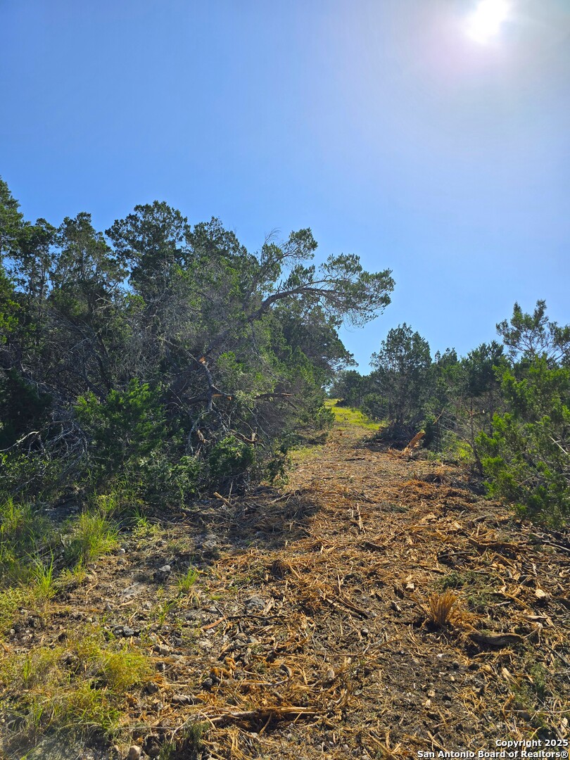227 Mitchell Ranch Road Camp Wood, TX 78833 - Photo 42 of 72 a view of a lake with a building in the background