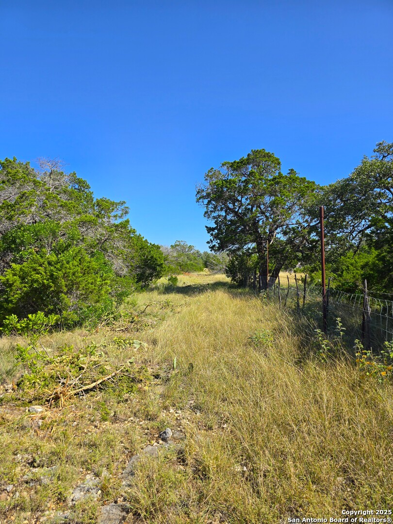 227 Mitchell Ranch Road Camp Wood, TX 78833 - Photo 53 of 72 a view of a lake with a house in the background