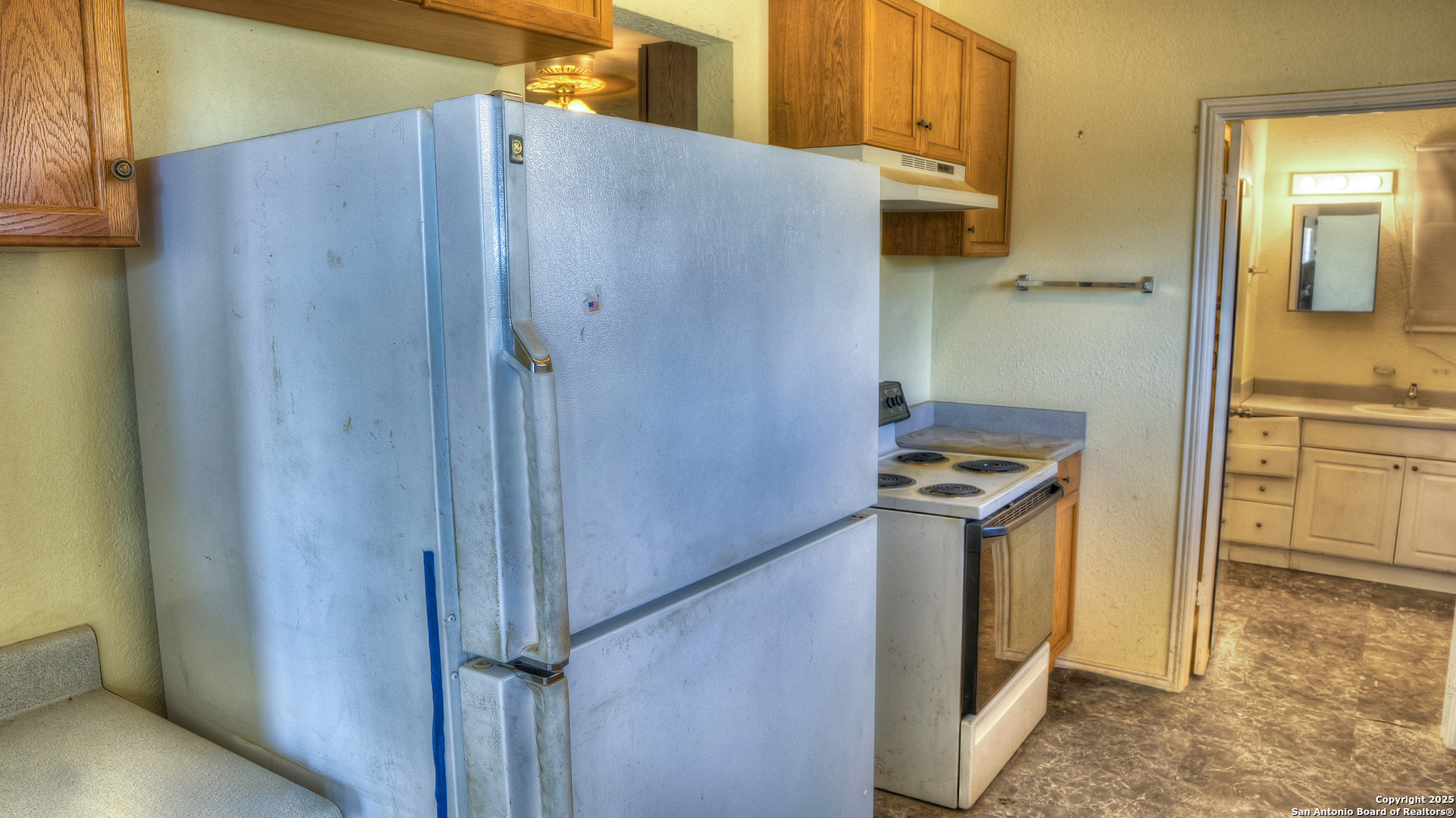 227 Mitchell Ranch Road Camp Wood, TX 78833 - Photo 6 of 72 a kitchen with a refrigerator and a stove