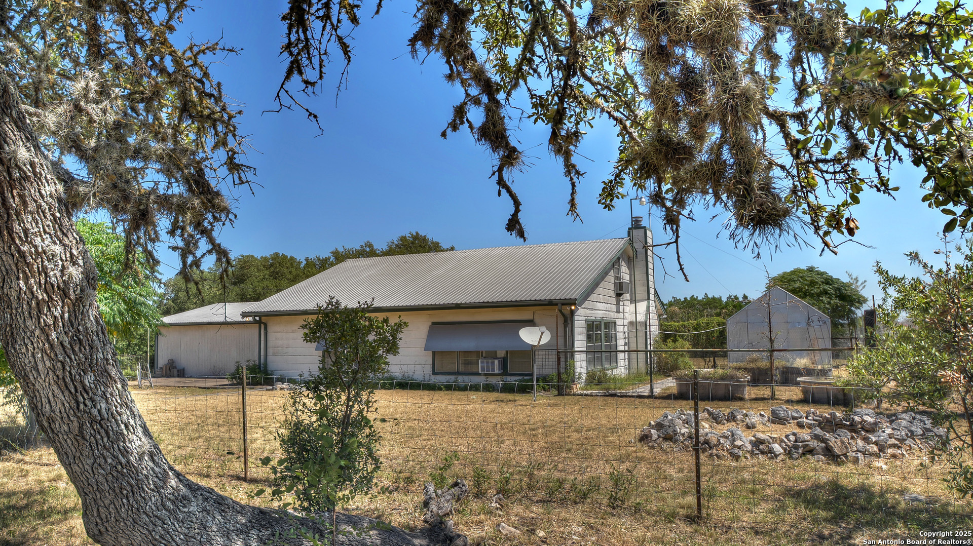 227 Mitchell Ranch Road Camp Wood, TX 78833 - Photo 70 of 72 a front view of a house with yard garage and tree