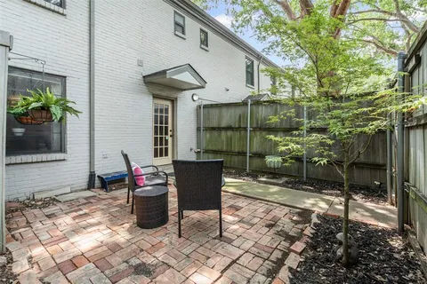 a view of a chairs and table in backyard of the house