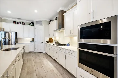a kitchen with stainless steel appliances a stove microwave and cabinets