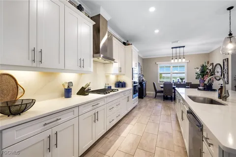 a large kitchen with stainless steel appliances lots of counter space and a sink