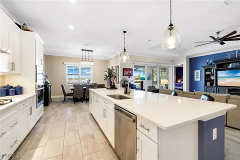 a large kitchen with kitchen island a sink a counter space and stainless steel appliances