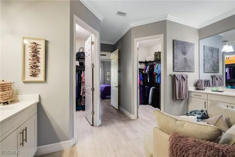 a living room with furniture and a walk in closet