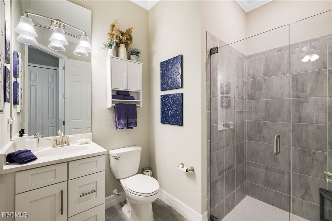 13424 Blue Bay Circle Fort Myers, FL 33913 - Photo 22 of 45 a bathroom with a sink toilet a mirror a vanity and shower
