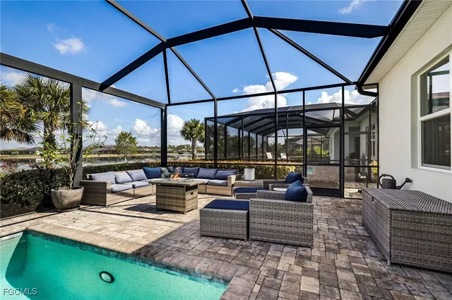 a outdoor living space with furniture and umbrella