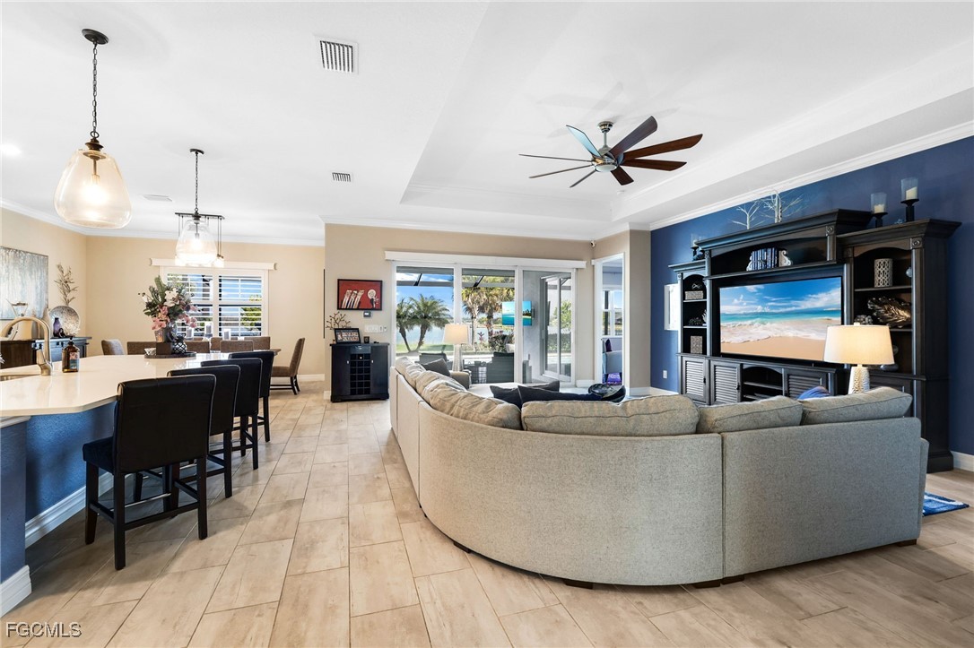 13424 Blue Bay Circle Fort Myers, FL 33913 - Photo 7 of 45 a living room with furniture a ceiling fan and a rug