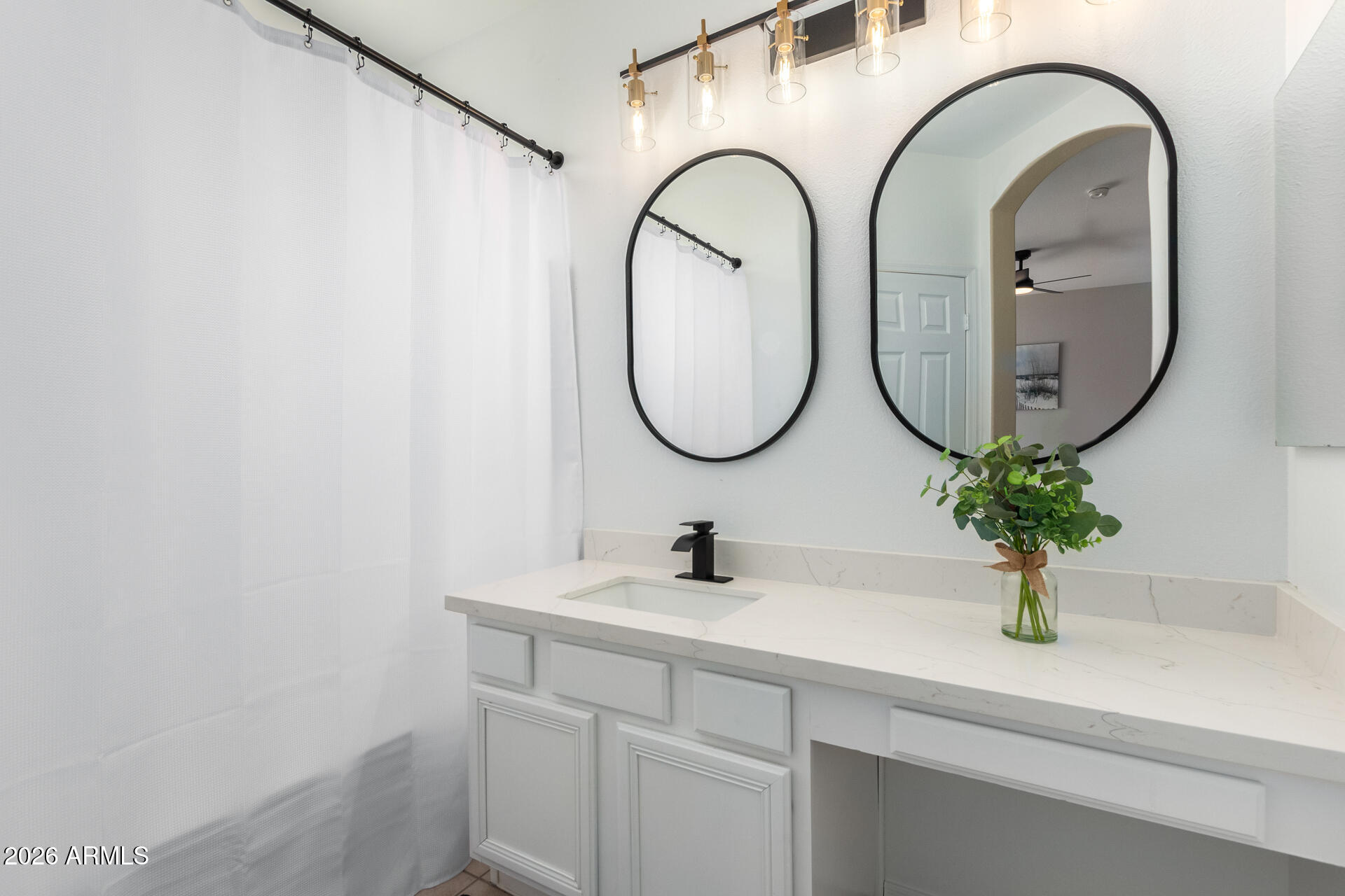 3674 South Joshua Tree Lane Gilbert, AZ 85297 - Photo 15 of 30 a bathroom with a sink and a mirror