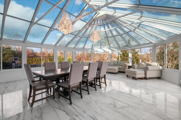 a view of a patio with table and chairs under an umbrella